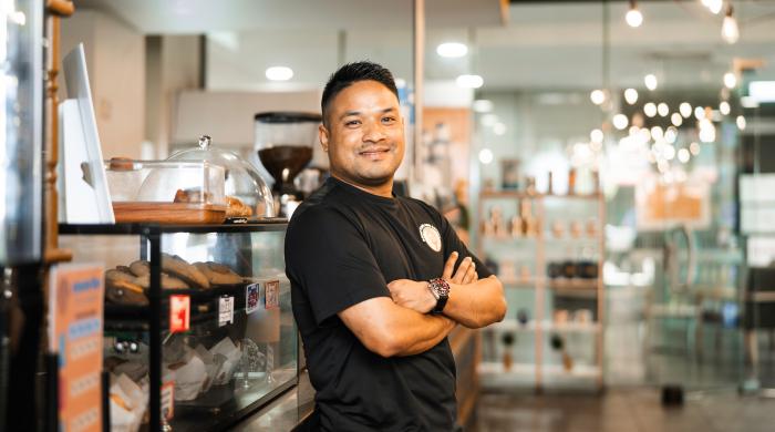 Prabin - Nepalese student posing in front of cafe